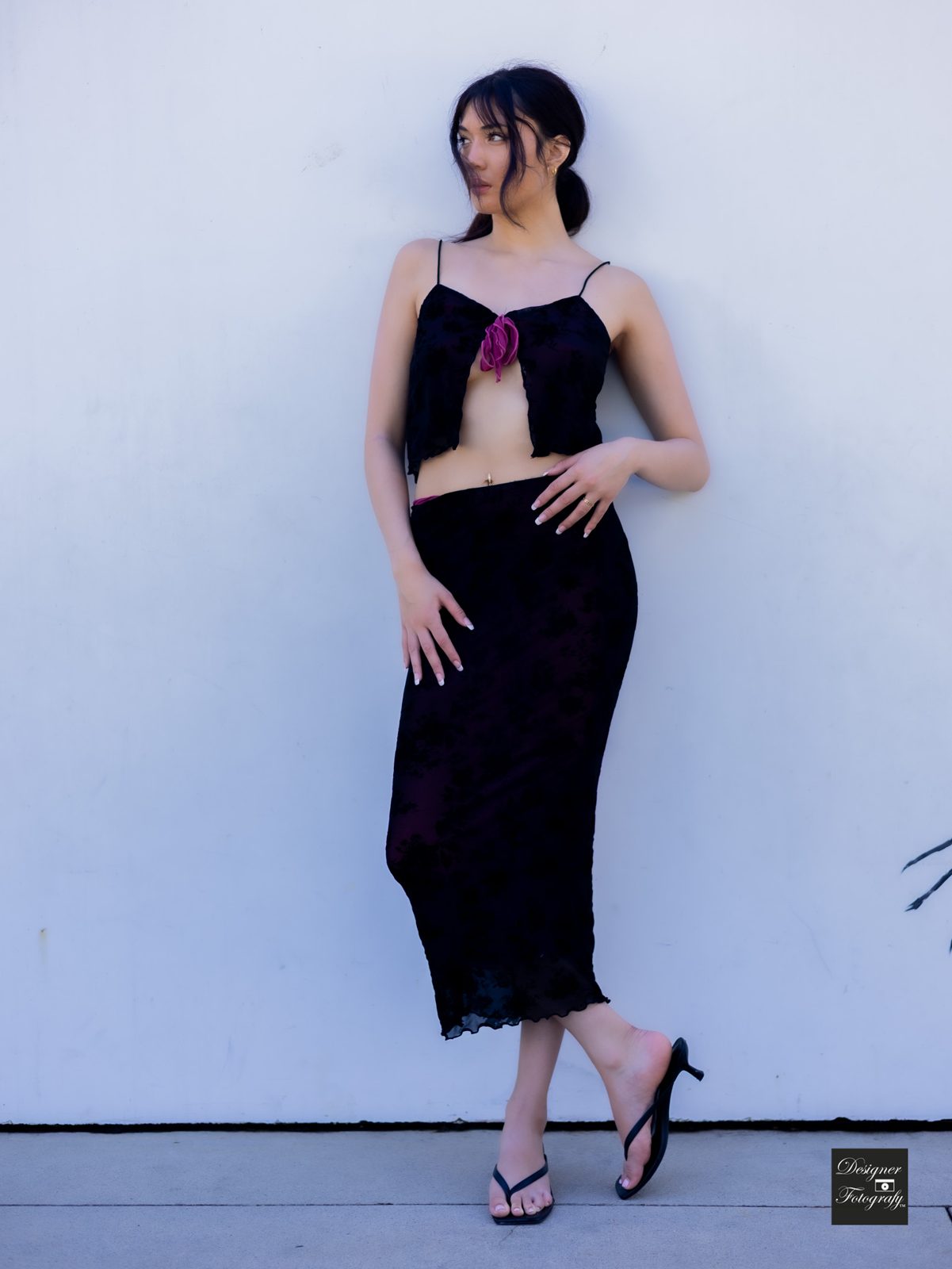 Full-length against a white wall